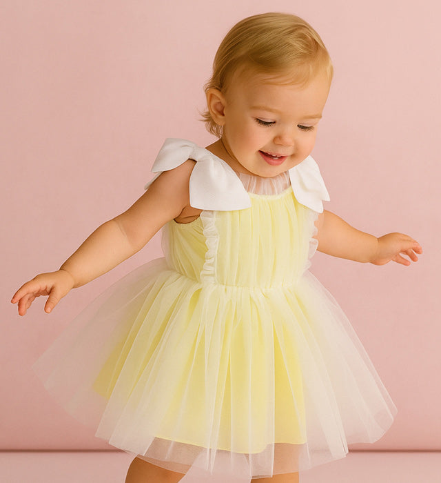 baby wearing yellow tulle dress