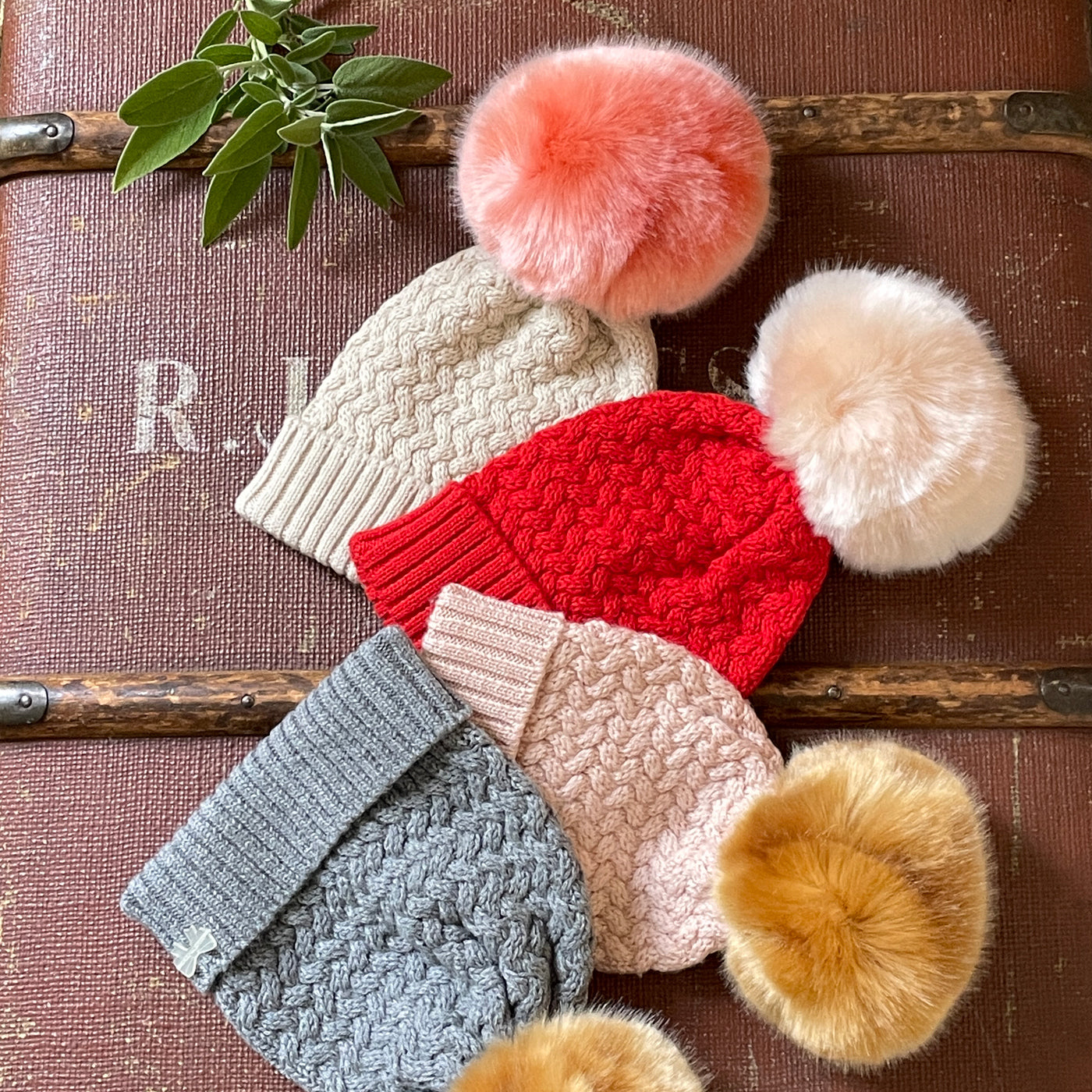 Knitted hats with pom poms