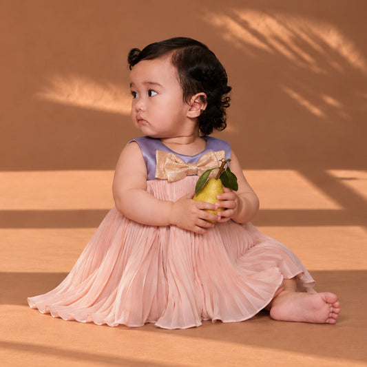 Toddler pleated trapeze dress with bow bodice and pink tulle skirt; bloomers not visible