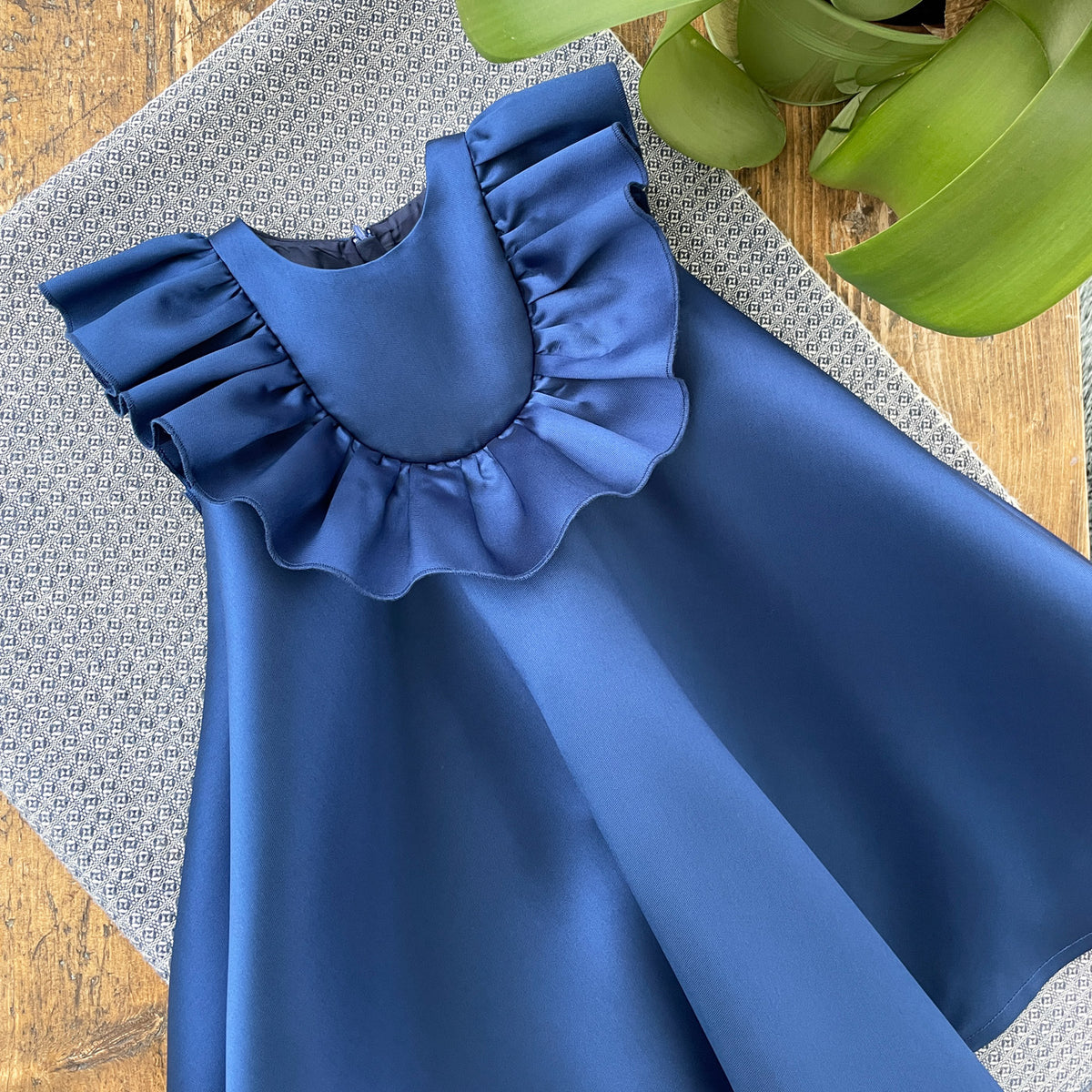 Blue ruffle bib trapeze dress with layered ruffle neckline