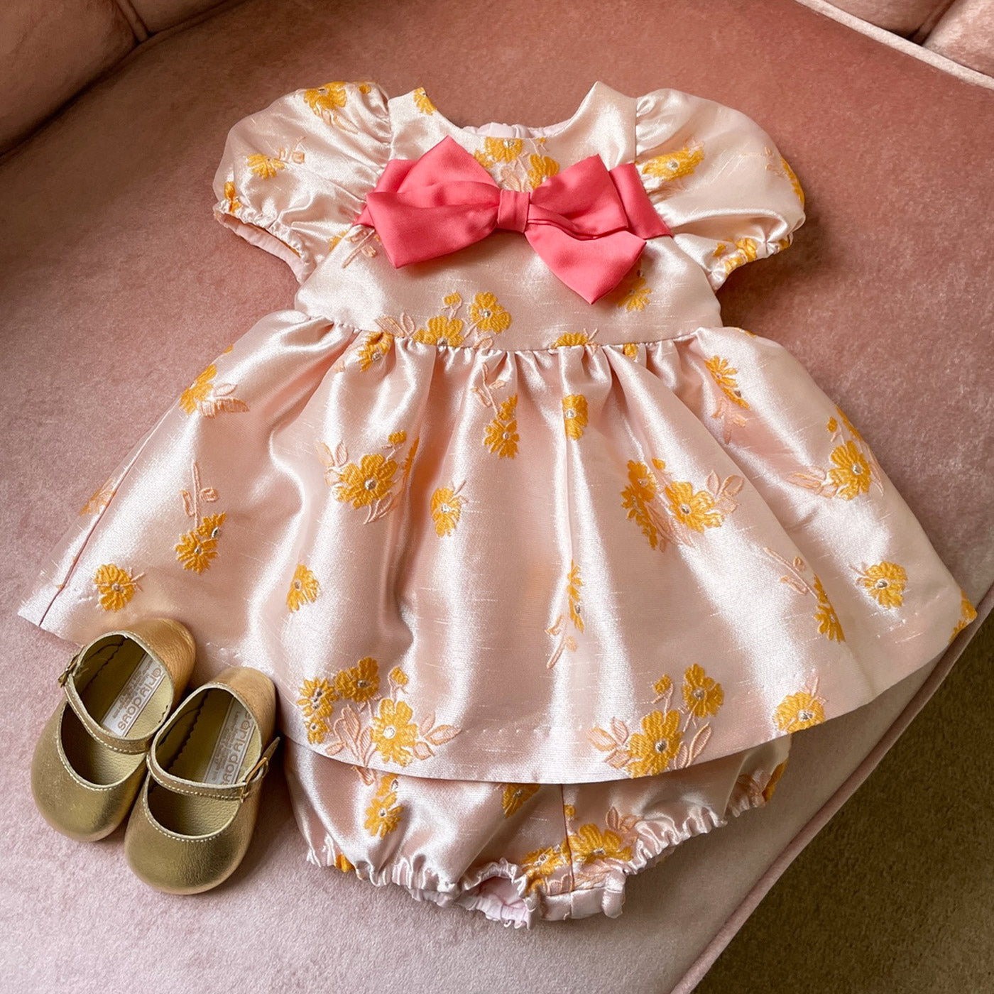 Pink floral dress with matching bloomers and coral satin bow