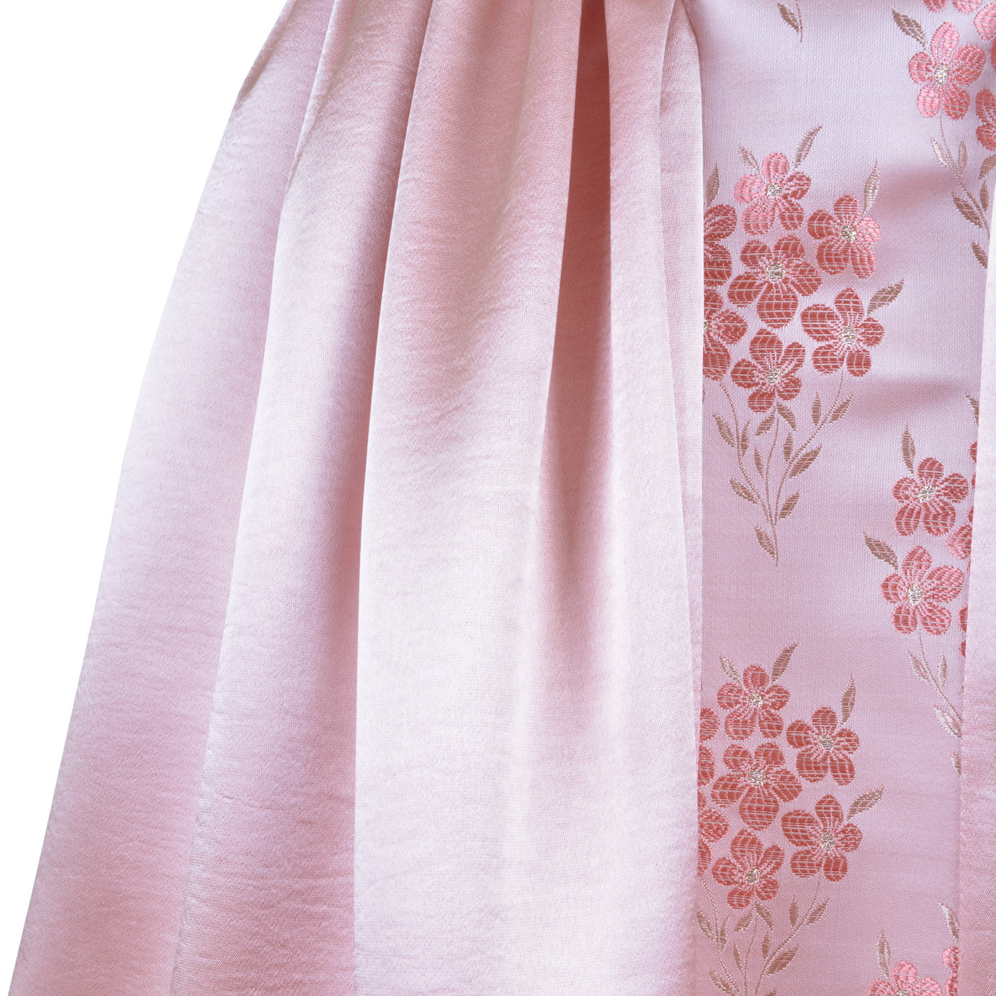 Pink floral midi dress fabric close-up with gathered skirt pleats
