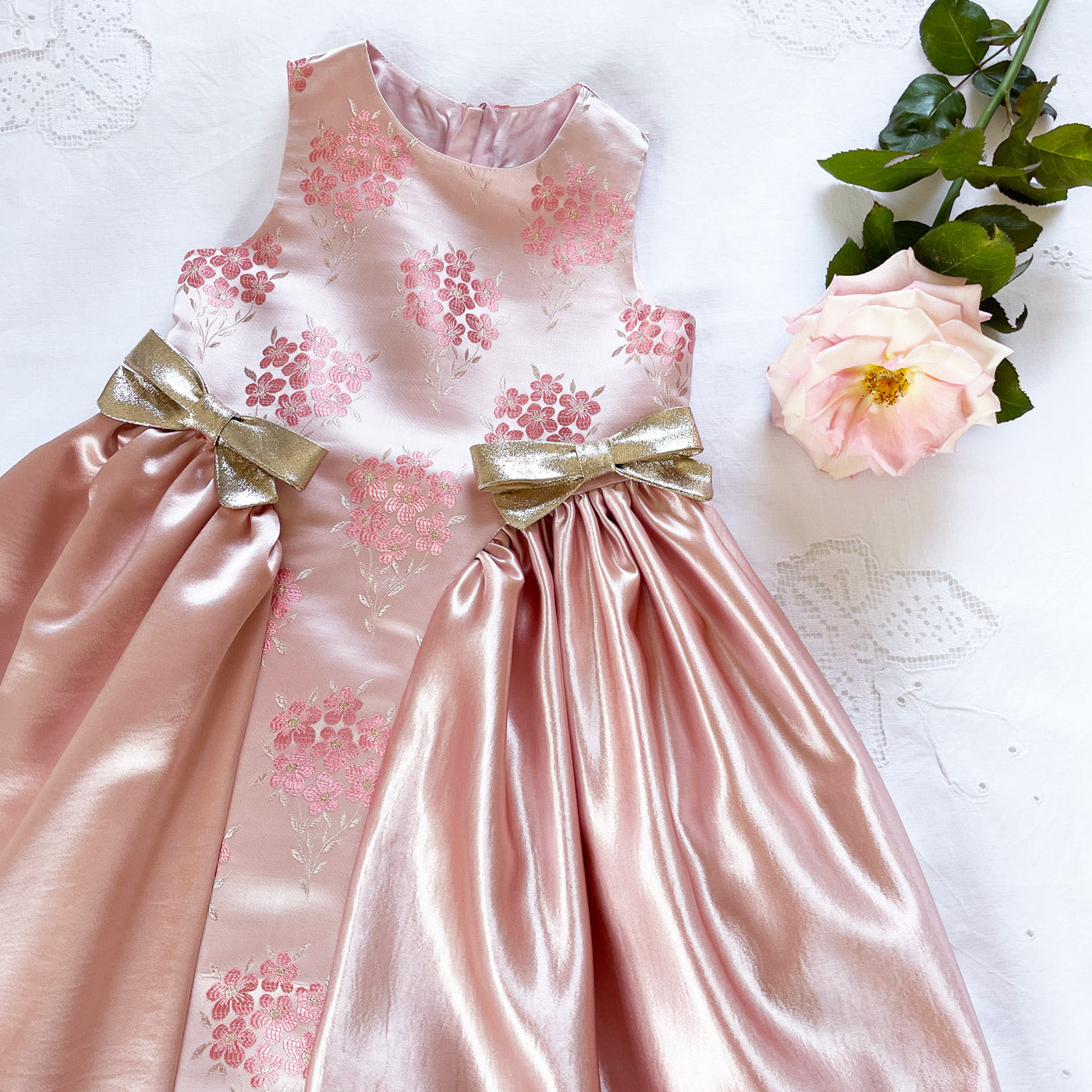Pink floral midi dress with gold bows and gathered full skirt