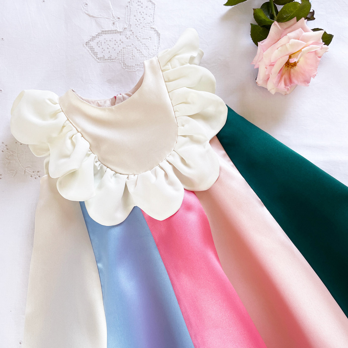 White ruffle bib rainbow stripe dress with layered puff sleeves and flared skirt