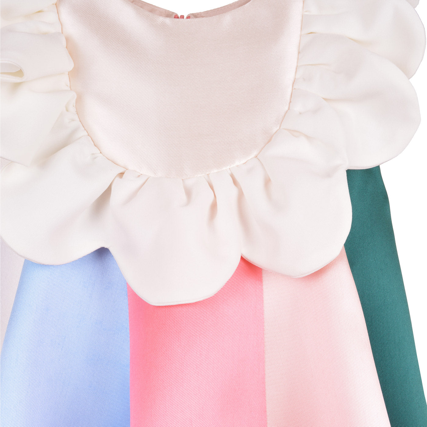 White ruffled bib with layered shoulder ruffles over pastel blue and pink skirt panels