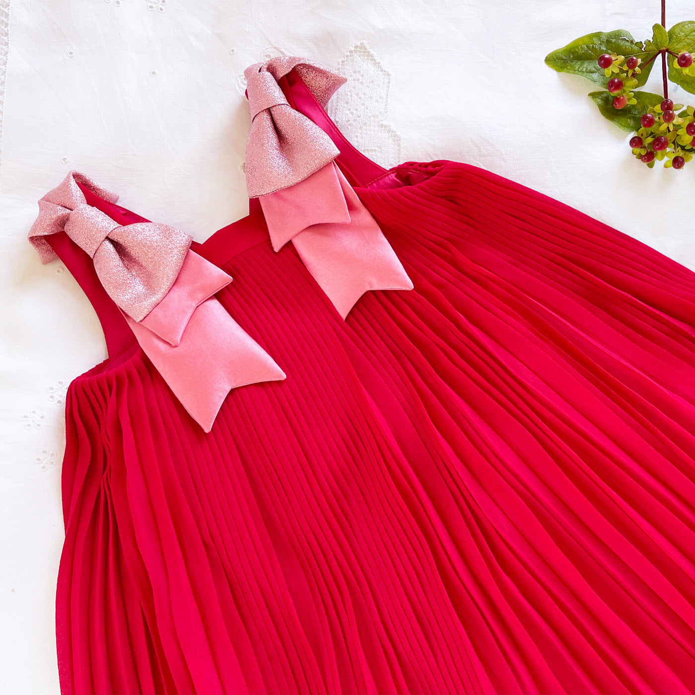 Fuchsia pleated trapeze dress with oversized pink bow shoulder ties