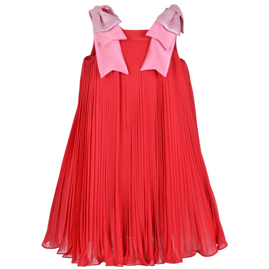 Red pleated trapeze dress with sleeveless yoke and pink bow ties at shoulders