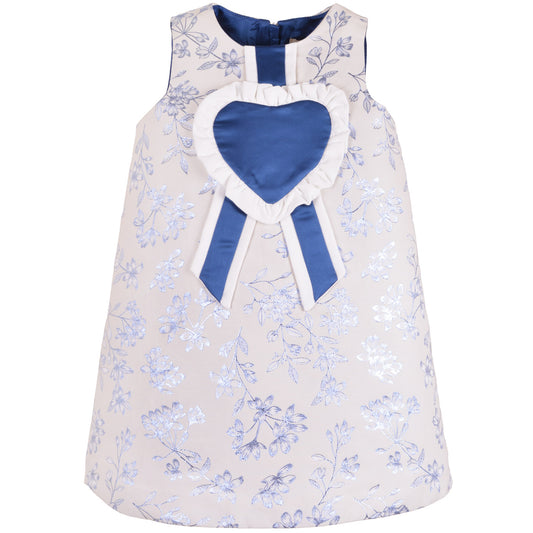Floral shift dress with navy heart bib rosette and striped ribbon accents at neckline.