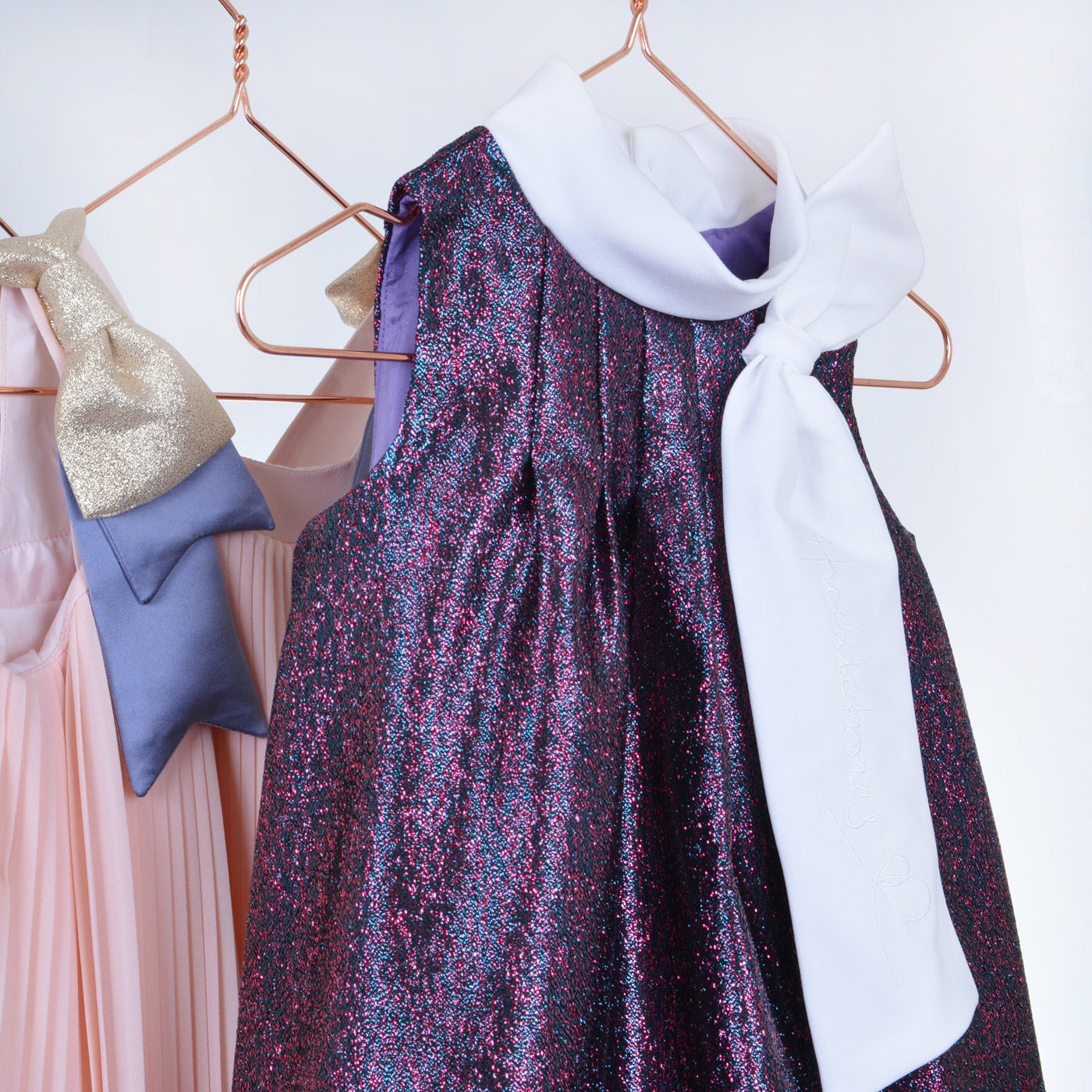 Speckled glitter sleeveless trapeze dress with wide white bow neck tie