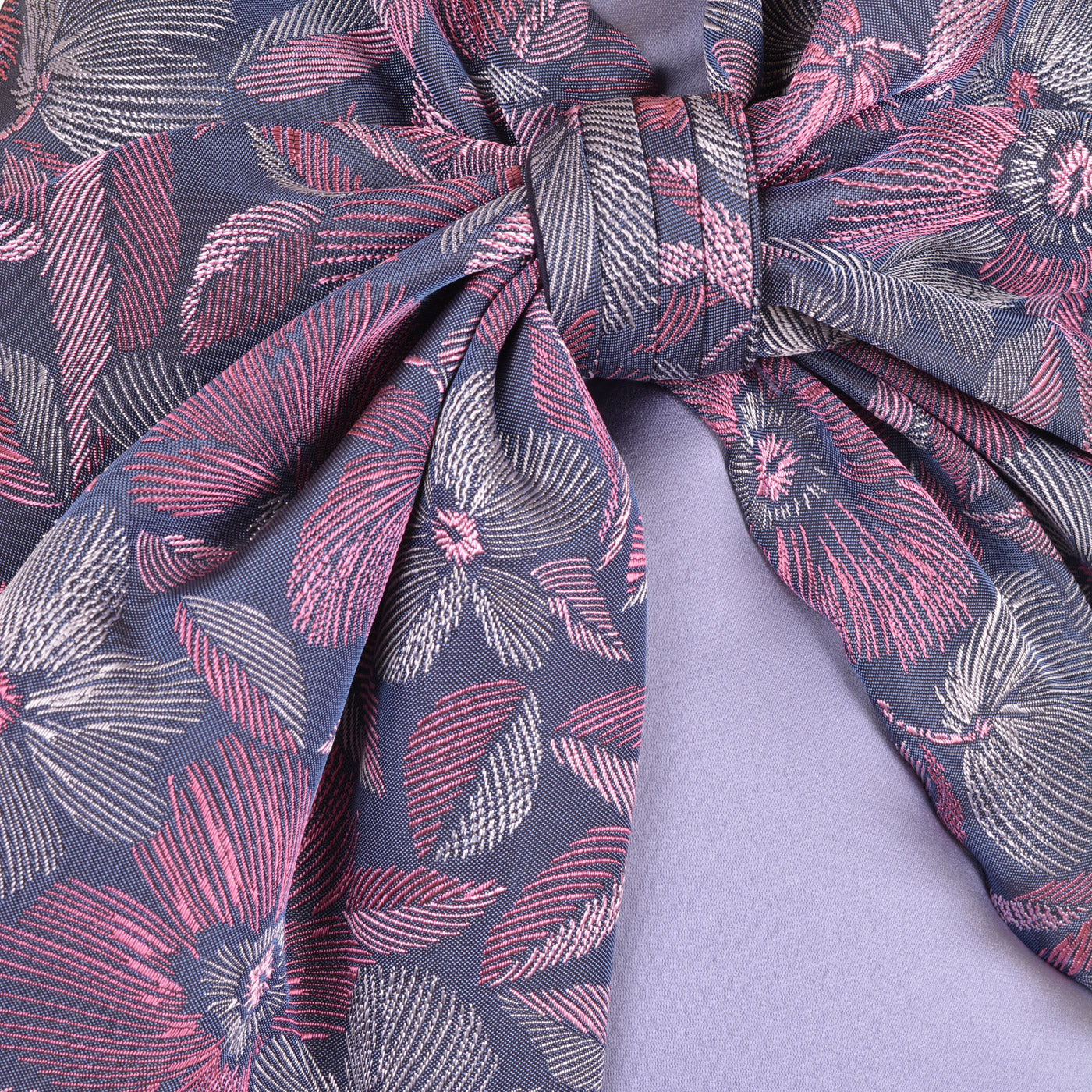 Floral bow detail on lavender shift dress bodice