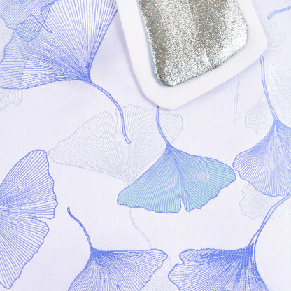 White dress fabric with blue floral print, long sleeve close-up