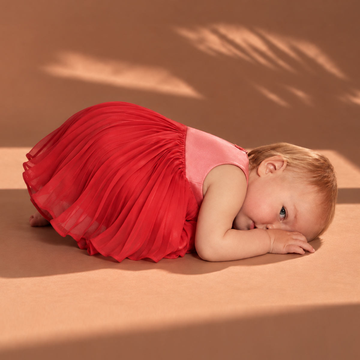 Pleated trapeze dress with matching red bloomers, sleeveless and pleated skirt