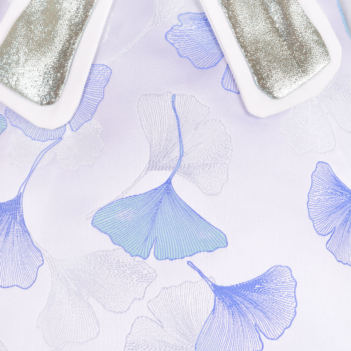 White dress fabric with raised blue ginkgo leaf pattern