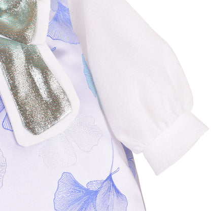 White dress sleeve with blue ginkgo print and iridescent gold glitter bow trim