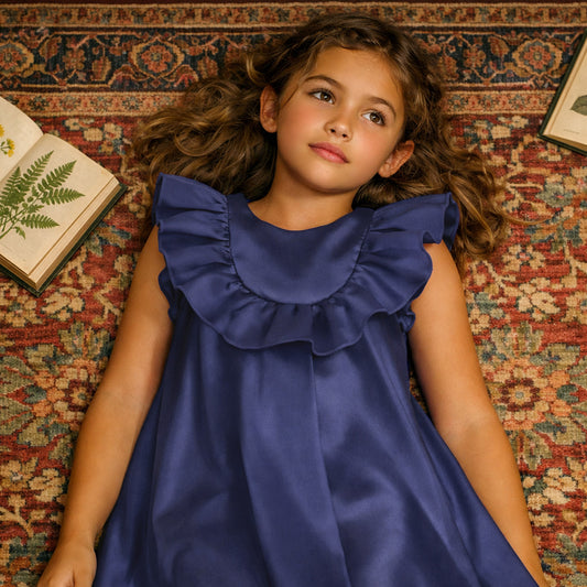 Blue sleeveless trapeze dress with ruffled bib neckline and layered shoulder frills