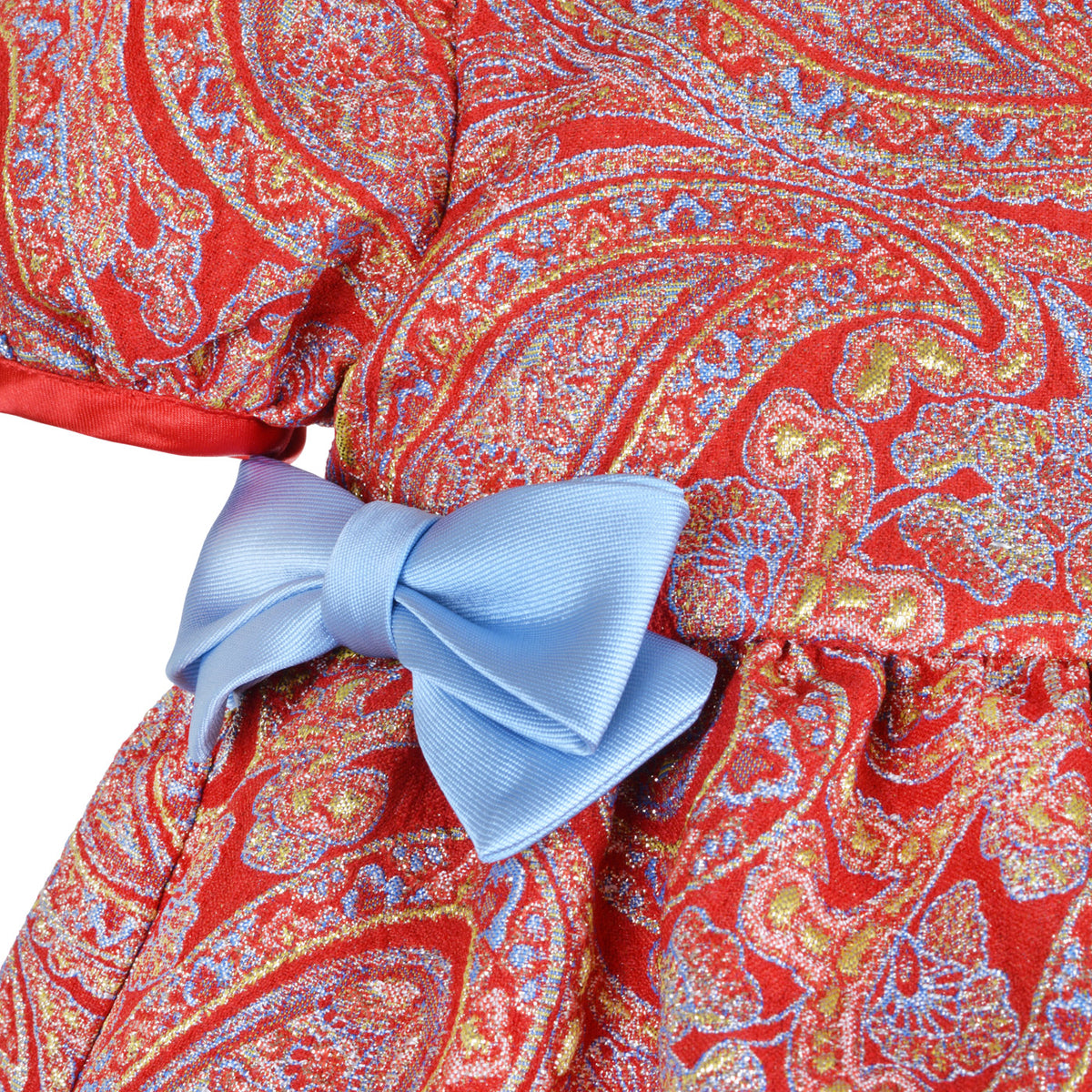 Red paisley dress close-up with light blue bow and gathered sleeve