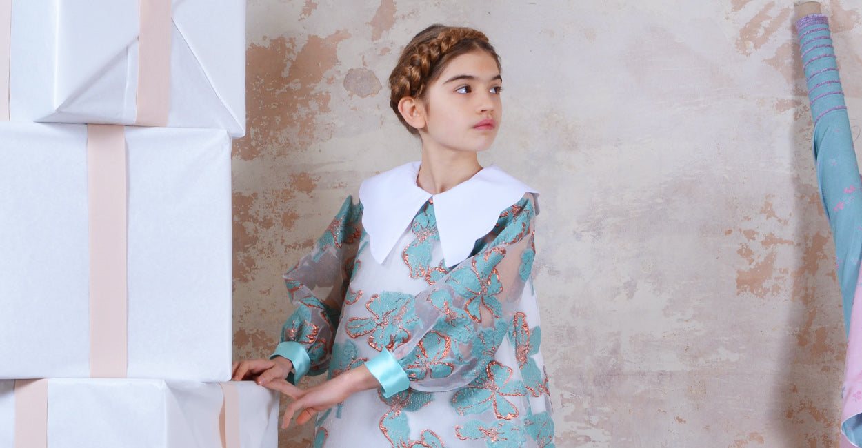 Girl wearing a Hucklebones Long Sleeved Shift Dress in Turquiose and Copper